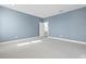 Bright bedroom with neutral carpet, and a large window allowing natural light to filter in at 34307 Radley Way, Wesley Chapel, FL 33545