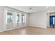 A spacious bedroom featuring three large windows, light-colored walls, and wood floors at 34307 Radley Way, Wesley Chapel, FL 33545