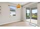 Bright dining area with sliding glass doors leading to a porch and a view of a peaceful pond at 34307 Radley Way, Wesley Chapel, FL 33545