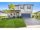 Beautiful two-story home with a well-maintained lawn and a paved driveway leading to a two-car garage at 34307 Radley Way, Wesley Chapel, FL 33545