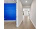 Hallway features hard wood flooring, recessed lighting, and a bright blue accent wall at 34307 Radley Way, Wesley Chapel, FL 33545