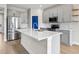 Modern kitchen features stainless steel appliances, a kitchen island, and a stylish backsplash at 34307 Radley Way, Wesley Chapel, FL 33545