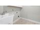 The laundry room features a wash sink and washer/dryer hookups at 34307 Radley Way, Wesley Chapel, FL 33545