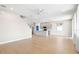 Open-concept living room flows into the kitchen and features hardwood floors throughout the space at 34307 Radley Way, Wesley Chapel, FL 33545
