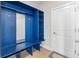 A beautiful blue mudroom features shelving and a bench by the door, providing style and function at 34307 Radley Way, Wesley Chapel, FL 33545