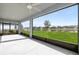 Spacious screened patio overlooking a lush green lawn and a tranquil lake, perfect for outdoor relaxation at 34307 Radley Way, Wesley Chapel, FL 33545