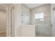 Tiled walk-in shower featuring a glass partition and window at 3818 Farm Garden Ct, Lakewood Ranch, FL 34211
