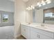 Bathroom with double vanity next to access to the toilet and a view to carpeted bedroom at 3818 Farm Garden Ct, Lakewood Ranch, FL 34211