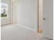 Well-lit bedroom boasts neutral carpet, base trim, and two bright white doors at 3818 Farm Garden Ct, Lakewood Ranch, FL 34211