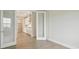 Bright bedroom features wood-look flooring and an open view to the adjacent white kitchen at 3818 Farm Garden Ct, Lakewood Ranch, FL 34211