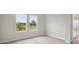 Bright bedroom with neutral walls and carpet with two windows offering natural light and outdoor views at 3818 Farm Garden Ct, Lakewood Ranch, FL 34211