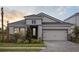 Charming single-Gathering home featuring a well-manicured lawn, stone accents, and a two-car garage at 3818 Farm Garden Ct, Lakewood Ranch, FL 34211