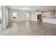 Spacious living room showcasing wood floors, an open layout, and access to the kitchen with modern finishes at 3818 Farm Garden Ct, Lakewood Ranch, FL 34211