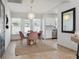 Bright dining area with a modern light fixture, table with chairs, and natural light from the patio doors at 4027 25Th N Ave, St Petersburg, FL 33713