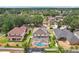 Aerial view of a home with a screened-in pool and well-manicured lawn in a residential neighborhood at 4224 Fleewell Ct, Valrico, FL 33596