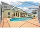 Large backyard with a screened-in pool and spa, ideal for relaxing and entertaining at 4224 Fleewell Ct, Valrico, FL 33596