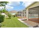 Lush backyard view showcasing a screened-in pool, verdant lawn, and mature landscaping at 4224 Fleewell Ct, Valrico, FL 33596