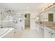 Bathroom featuring a marble shower, granite counters, dual sinks and a soaking tub at 4224 Fleewell Ct, Valrico, FL 33596