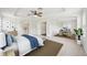 Spacious bedroom with a tray ceiling, ceiling fan, and a view to the bathroom at 4224 Fleewell Ct, Valrico, FL 33596