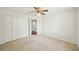 Bedroom with ceiling fan, closet and door to adjoining bathroom at 4224 Fleewell Ct, Valrico, FL 33596