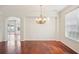 Inviting dining room featuring hardwood floors, chandelier, and natural light, perfect for entertaining at 4224 Fleewell Ct, Valrico, FL 33596