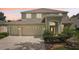 Charming two-story home featuring a three car garage, well-maintained landscaping, and a classic entryway with a decorative door at 4224 Fleewell Ct, Valrico, FL 33596