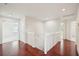 Bright hallway with hardwood floors and a white staircase at 4224 Fleewell Ct, Valrico, FL 33596