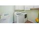 Well-lit laundry room features white cabinets and modern washer and dryer units at 4224 Fleewell Ct, Valrico, FL 33596