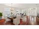 Elegant living room featuring hardwood floors, natural light, chandelier, and furniture staging at 4224 Fleewell Ct, Valrico, FL 33596