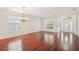 Spacious living room featuring hardwood floors, abundant natural light, and a chandelier at 4224 Fleewell Ct, Valrico, FL 33596