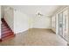 Spacious living room with tile floors, ceiling fan, and staircase at 4224 Fleewell Ct, Valrico, FL 33596