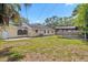 A view of the home's backyard with grass and a covered carport at 5015 15Th S Ave, Gulfport, FL 33707