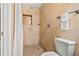 Tiled shower with a shower head, a tiled shower niche, and a toilet at 5015 15Th S Ave, Gulfport, FL 33707