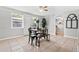 Sunny dining room area with table, chairs, neutral walls, and ceiling fan at 5015 15Th S Ave, Gulfport, FL 33707