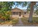 Charming front exterior of a tan home with a covered porch and a walkway at 5015 15Th S Ave, Gulfport, FL 33707