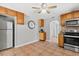 A view of the kitchen featuring wooden cabinets, a stove, tile floors, and an open doorway at 5015 15Th S Ave, Gulfport, FL 33707