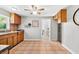 A view of the kitchen featuring wooden cabinets, a window, tile floors, and an open doorway at 5015 15Th S Ave, Gulfport, FL 33707