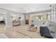 Comfortable living room with large windows, wood door, and stylish furnishings at 5015 15Th S Ave, Gulfport, FL 33707