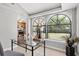 Office room with a glass desk, a large window, and views of the backyard at 5015 15Th S Ave, Gulfport, FL 33707