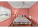 Cozy bedroom with matching bedside lamps, window, and warm lighting at 520 Canal Way, Oldsmar, FL 34677