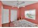 Comfortable bedroom featuring wood-look floors, a ceiling fan, and a sun-drenched window at 520 Canal Way, Oldsmar, FL 34677