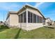 Home exterior with enclosed porch and well-maintained lawn in a beautiful neighborhood at 520 Canal Way, Oldsmar, FL 34677