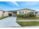 Charming single-story home featuring a carport, garage, and well-maintained landscaping at 520 Canal Way, Oldsmar, FL 34677