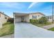 Single-story home with carport, garage, manicured landscape, and vibrant bougainvillea at 520 Canal Way, Oldsmar, FL 34677