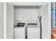 Bright laundry room with a modern washer and dryer, complemented by ample cabinet storage at 520 Canal Way, Oldsmar, FL 34677