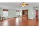 Bright living room with laminate floors, ceiling fan, windows, vintage hutch and light green walls at 520 Canal Way, Oldsmar, FL 34677