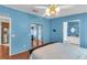 Spacious bedroom with laminate floors and a view to the bathroom, walk-in closet, and the kitchen at 520 Canal Way, Oldsmar, FL 34677
