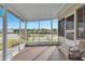 Enclosed porch offers a tranquil view of the adjacent waterway and the surrounding landscape at 520 Canal Way, Oldsmar, FL 34677