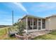Cozy screened porch with river views and a small deck extending into the yard at 520 Canal Way, Oldsmar, FL 34677