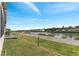 Picturesque waterway view featuring lush greenery, neighboring homes, and a walking path at 520 Canal Way, Oldsmar, FL 34677
